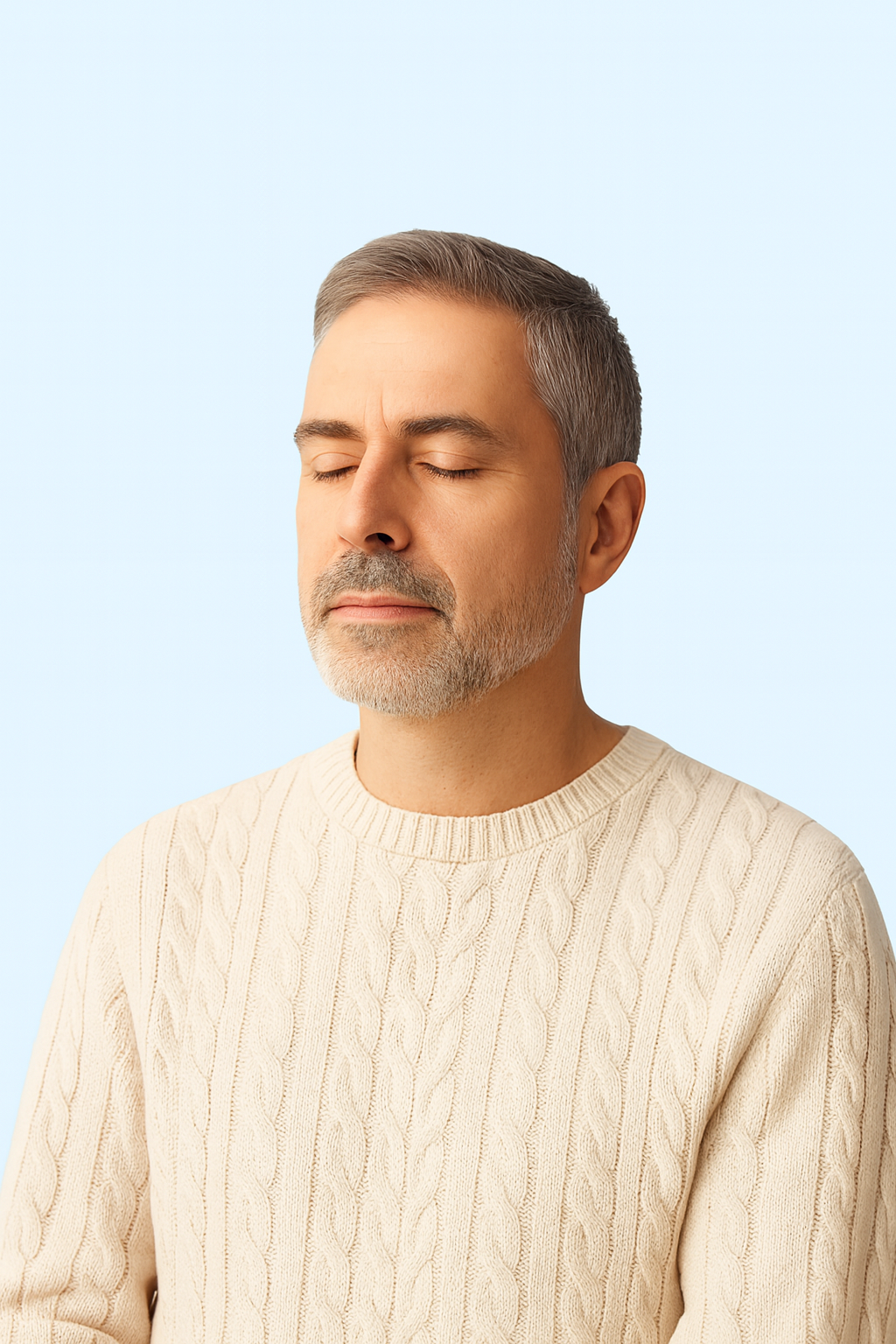Calm middle-aged man with closed eyes, wearing a light sweater